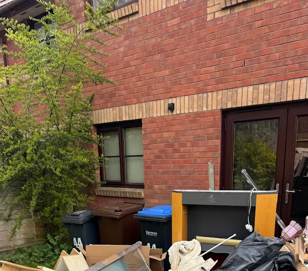 Before waste clearance in KT16 Surrey showing renovation waste and bulky items