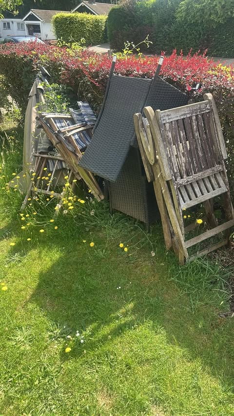 Before garden furniture clearance in Welwyn Garden City AL8 showing old tables, chairs and umbrella